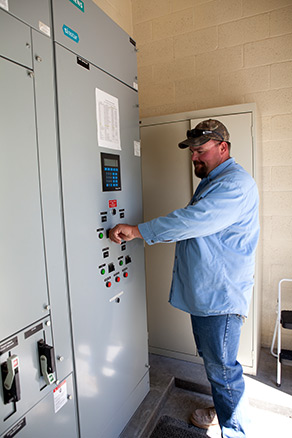 FHSD employee adjusting levels at pump station